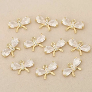 Detalle de colgantes de mariposa bañados en oro con circonitas para joyería DIY