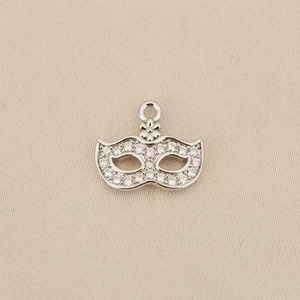 Detail of bohemian mask pendant with silver finish and white crystal stone embellishments