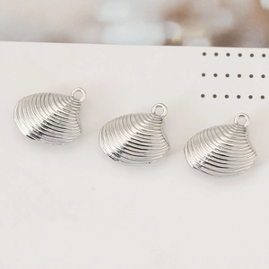 Three silver seashell metal pendants with ribbed texture for DIY jewelry making