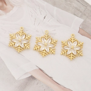 Three gold snowflake charms with sparkling cubic zirconia for DIY jewelry making