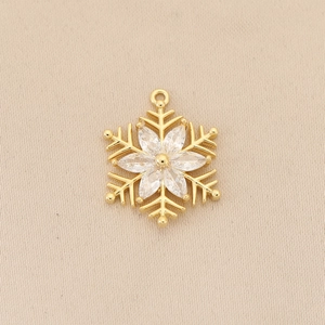 Macro view of gold-plated snowflake pendant with marquise-cut zircon stones and ring loop