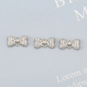Silver bow pendant with micro-pave cubic zirconia and dual loops for DIY jewelry