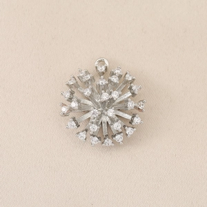 Macro detail of silver plated floral pendant with micro-pave cubic zirconia settings
