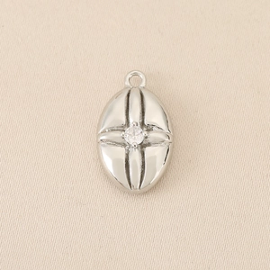 Detailed macro view of vintage oval silver pendant with centered sparkling cubic zirconia stone