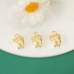 Three gold smiling tooth pendants with hats for DIY jewelry necklaces and bracelets