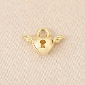 Detailed close-up of a 18K gold plated heart lock pendant with wings for jewelry making