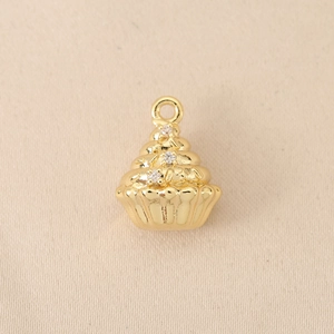Macro detail of 18K gold-plated cupcake pendant featuring three sparkling zircon stones