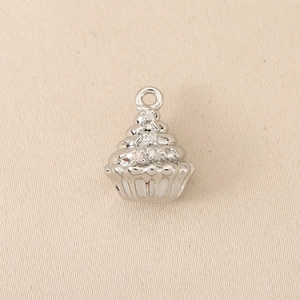 Detailed view of silver cupcake pendant with polished swirls and sparkling zircon accents