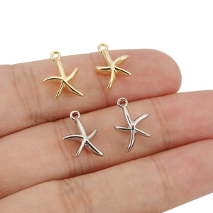 Polished 18k gold and silver starfish charms shown in hand for size and detail