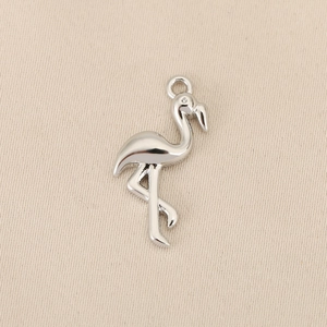 Detailed view of a polished silver flamingo pendant for DIY jewelry making and crafts