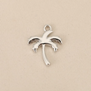 Close-up of silver palm tree pendant with polished mirror finish for DIY jewelry