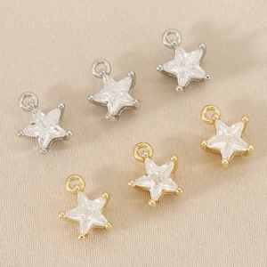Detail of 18k gold and silver star pendants with sparkling cubic zirconia for DIY jewelry
