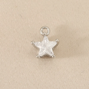 Detail showing high-quality star-shaped zirconia pendant with polished gold plating