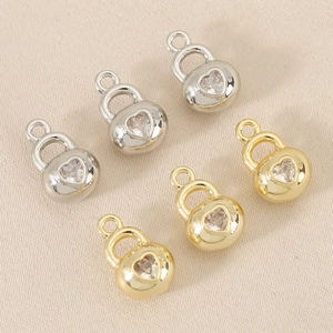 Detail of 18k gold heart padlock pendants with inlaid zircon crystals for DIY jewelry