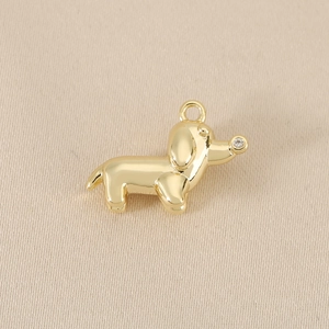 Detailed view of a gold dachshund pendant featuring a sparkling zircon nose accent