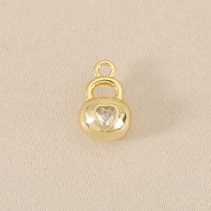 Detailed close-up of an 18k gold-plated heart lock pendant with sparkling zircon stone