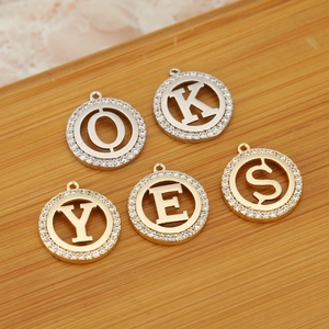 Set of gold and silver letter pendants O K Y E S with sparkling pavé cubic zirconia