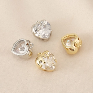 Detailed macro view of heart-shaped zircon pendants with unique melting metal design