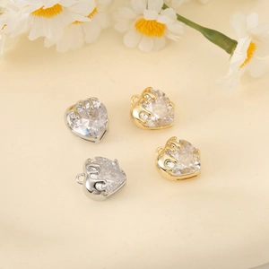 Macro shot of 18K gold and silver heart zirconia pendants for DIY jewelry making