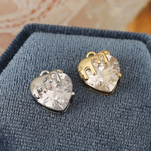 Macro view of heart-shaped zircon pendants with unique liquid metal drip design