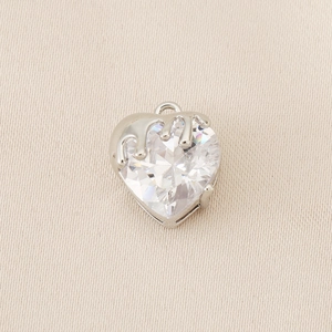 Macro detail of heart-shaped zircon pendant with modern fluid silver-plated metal design