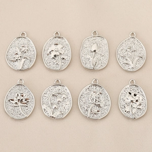 Detailed set of eight silver-plated floral relief pendants for DIY jewelry making and crafts