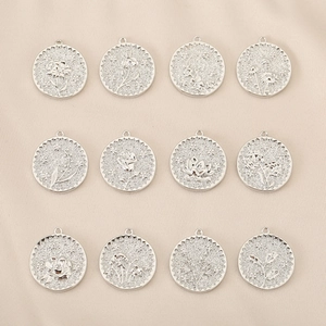 Set of 12 silver flower relief pendants with detailed floral engravings for DIY jewelry