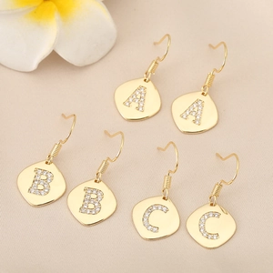 Vintage gold 18K square drop earrings with rhinestone A B C letters on beige background