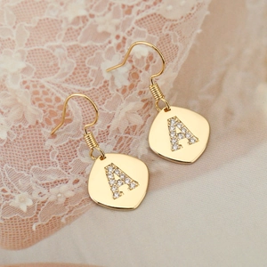 Vintage style golden earrings with letter A pendant in cubic zirconia and fishhook design