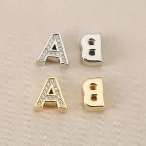 Detail of 18K gold letter A with rhinestones and silver letter B for DIY jewelry