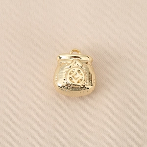 Macro shot of 18K gold plated money bag pendant with intricate coin texture