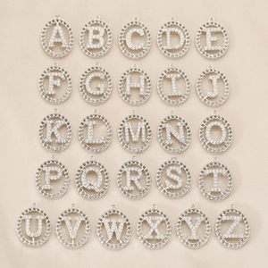 26 alphabet pendants set with micro-paved cubic zirconia in a silver textured round frame