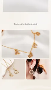 Close-up of 18K gold plated heart and letter pendants with cubic zirconia inlay details