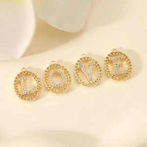Detailed view of gold plated LOVE letter pendants with zircon inlay for DIY jewelry