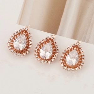 Detailed macro view of pear shaped rose gold pendants with sparkling cubic zirconia inlay