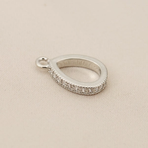 Macro view of teardrop pendant with 18K silver plating and micro-pave zircon crystals