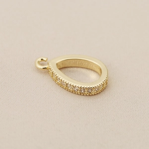 Detail view of 18K gold-plated teardrop pendant with micro-pave cubic zirconia crystals