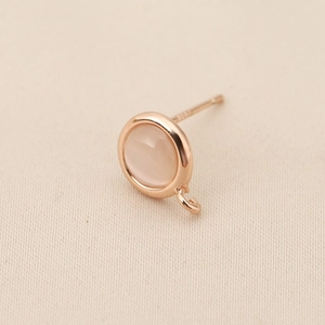 Macro detail of 18k gold plated S925 silver earring post with pink gemstone and diy loop
