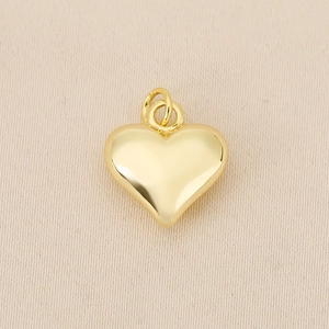 Close-up of heart-shaped 18K gold-plated solid copper pendant with double rings