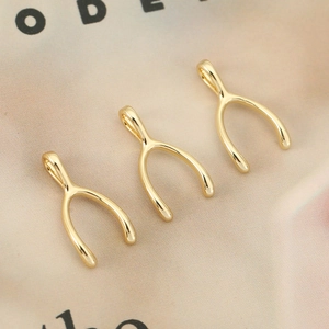 18K gold plated wishbone pendant for DIY jewelry making on soft satin background
