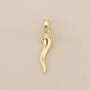 Vue macro du pendentif piment en cuivre plaqué or 18K avec finition miroir polie