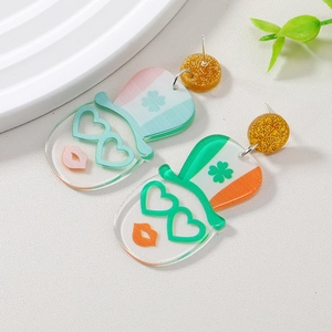St. Patrick's Day acrylic earrings with leprechaun hat and clover pattern on white marble