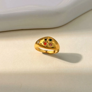 Detail of 18K gold-plated signet ring with five colored gemstones and starburst engraving