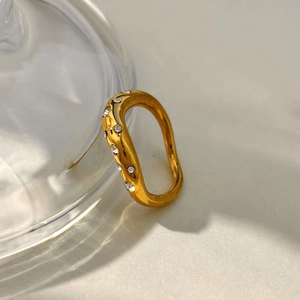 Detailed close-up of a wavy 18K gold-plated stainless steel ring with micro-set zircon