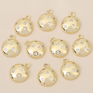 Detailed macro view of 18k gold plated round pendants with sparkly zircon stones