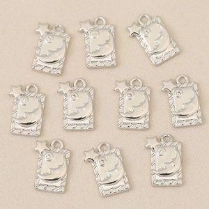 Detailed view of ten silver rectangular pendants with moon and star zircon details
