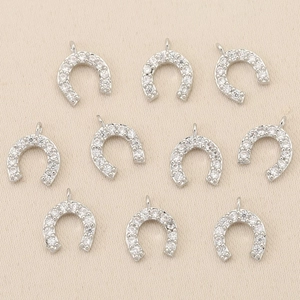 Macro shot of 10 silver U-shaped horseshoe charms with CZ micro-pave for DIY jewelry