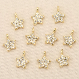 Detailed view of ten 18k gold plated star pendants with inlaid cubic zirconia for jewelry DIY