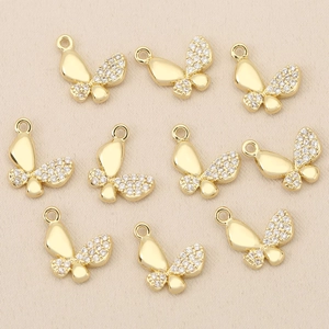 Detailed view of ten gold-plated butterfly charms with white zircon inlay for jewelry making