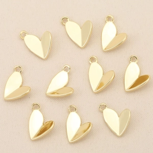 Detailed view of 18k gold plated 3D heart-shaped pendants for DIY jewelry making